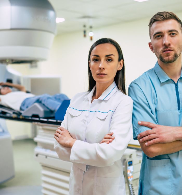 A woman and a man standing in front of a machine.