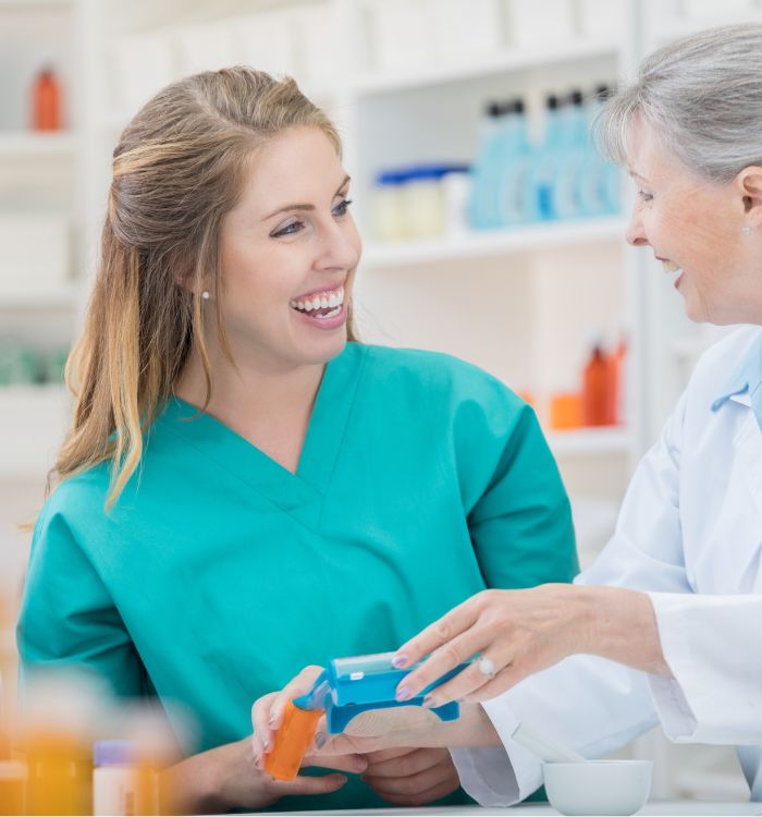 A woman in a blue shirt is holding a blue case.