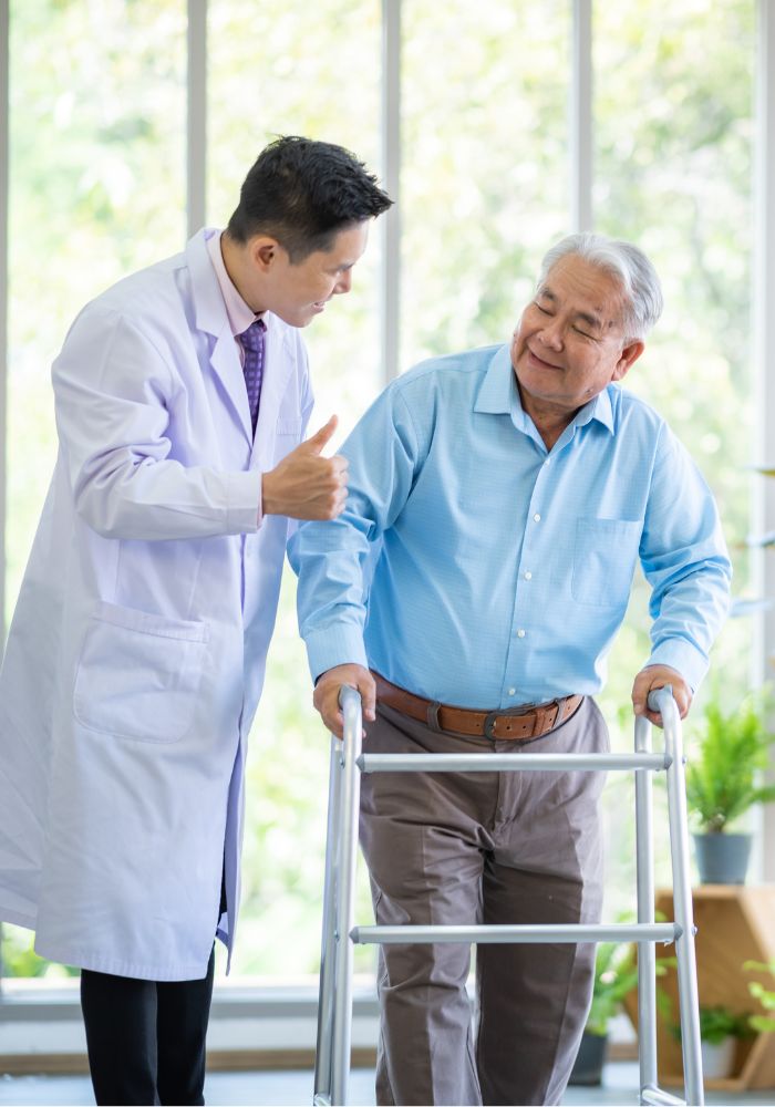 A man in a blue shirt and a man in a white coat are talking to each other.