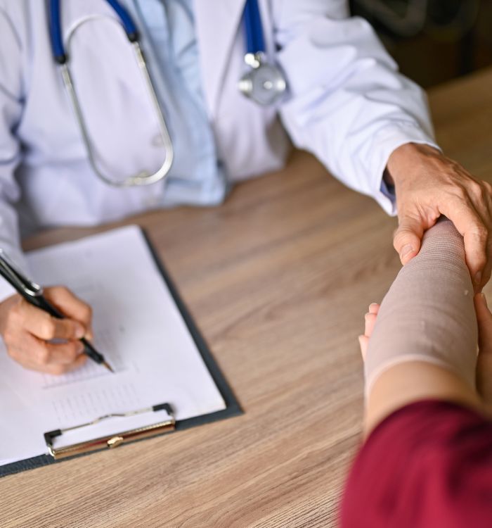 A doctor examining a patient with a broken arm.