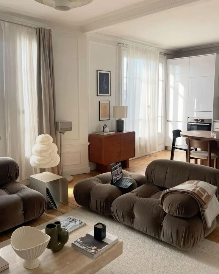 This may contain: a living room filled with furniture and a flat screen tv