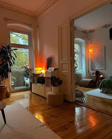 This may contain: a living room filled with furniture and a large window