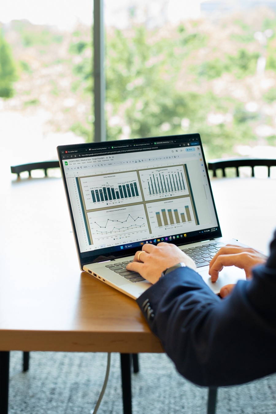 Healthcare practice owner reviewing financial reports and calculating debt-to-income ratio to evaluate business financial health in Texas