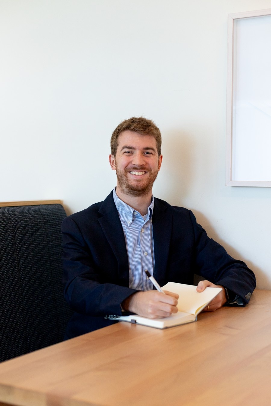  Dentist reviewing financial reports with advisor to improve practice growth and cash flow in Richardson Texas