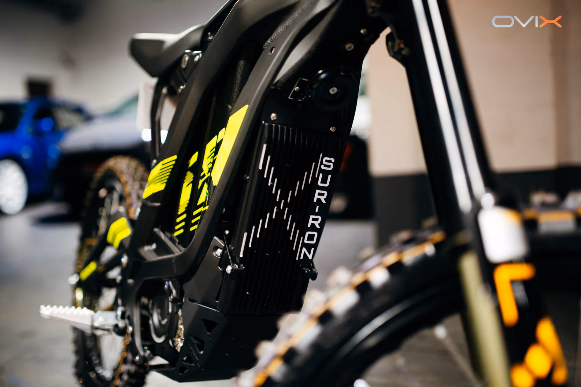 Close-up of a black and yellow Sur-Ron electric bike focusing on the rear frame and tire.
