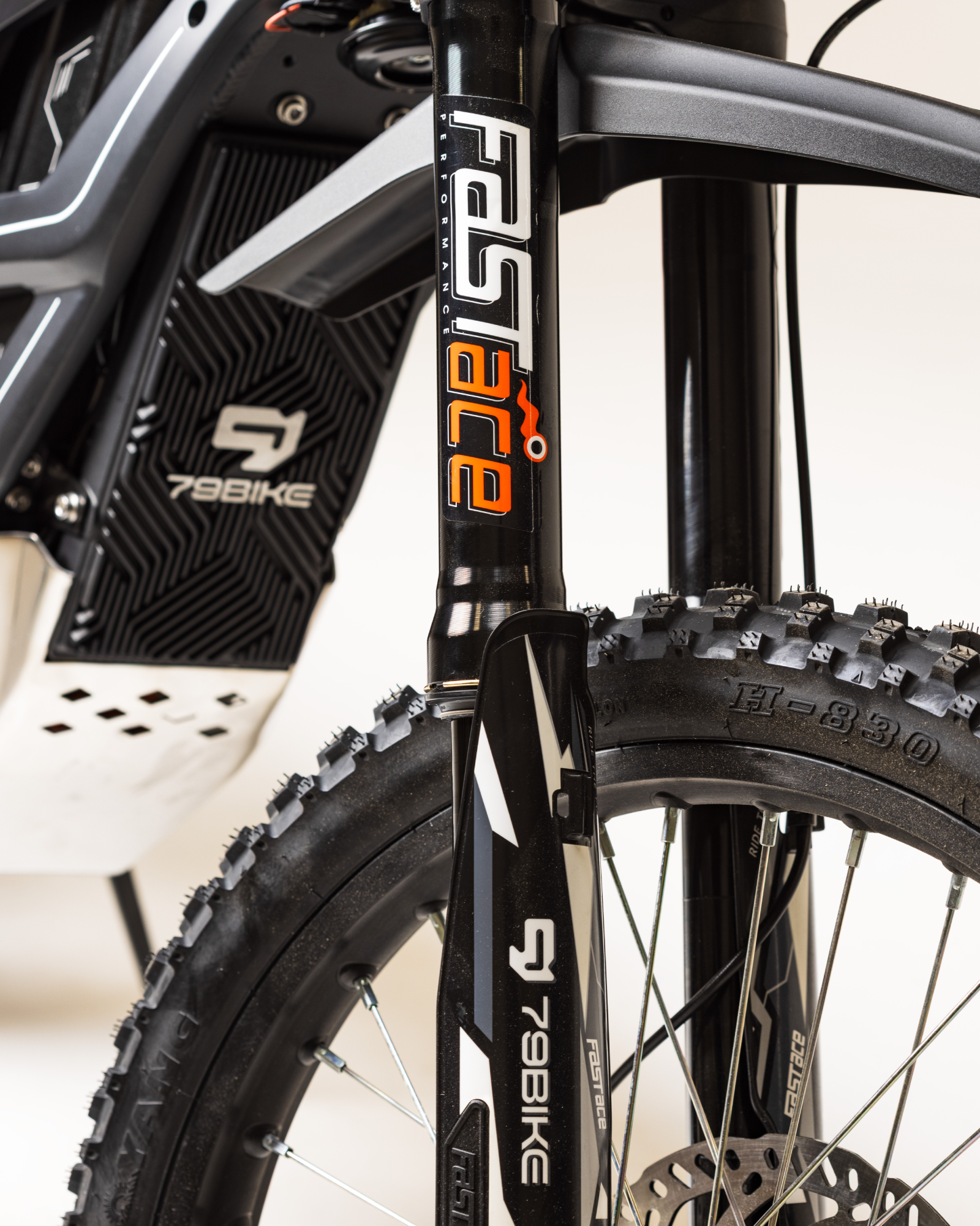 Close-up of 79BIKE electric bike front suspension fork and tire with FastAce branding.