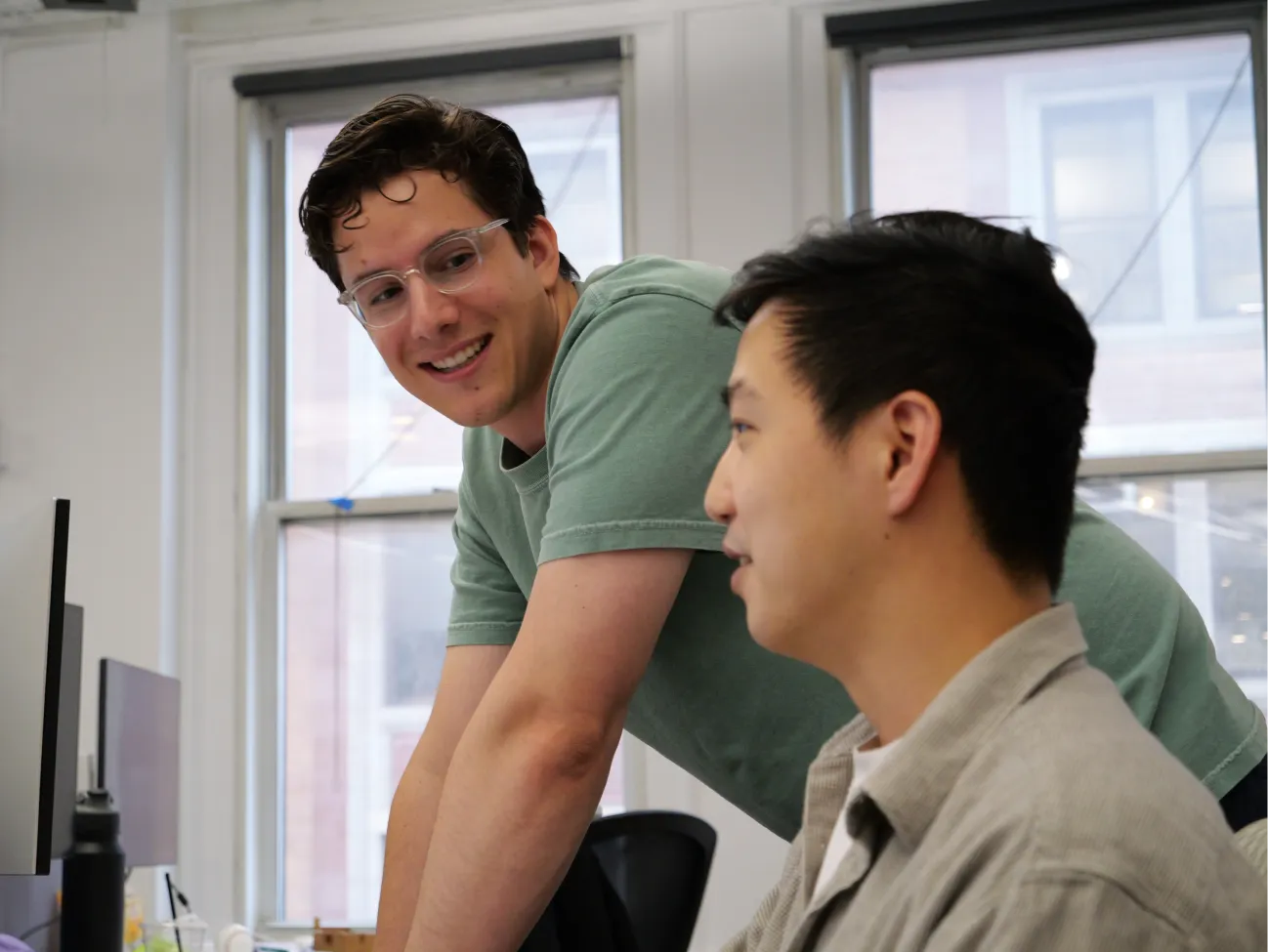 two men talking in an office environment