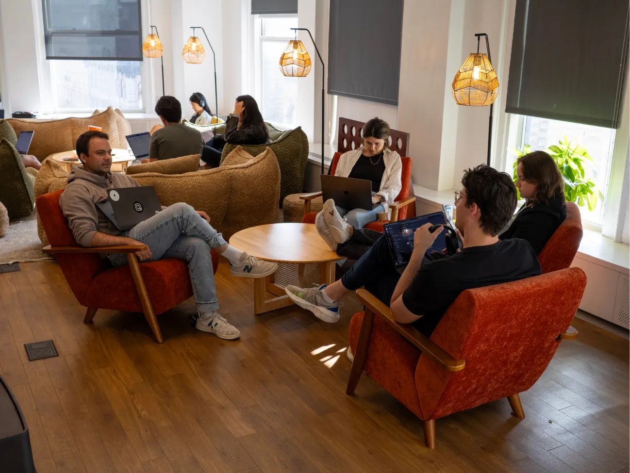 a group of people sitting on lounge furniture