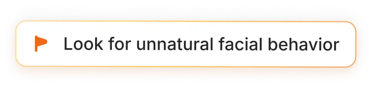 Orange rectangular button with a small orange flag icon and the text 'Look for unnatural facial behavior'.