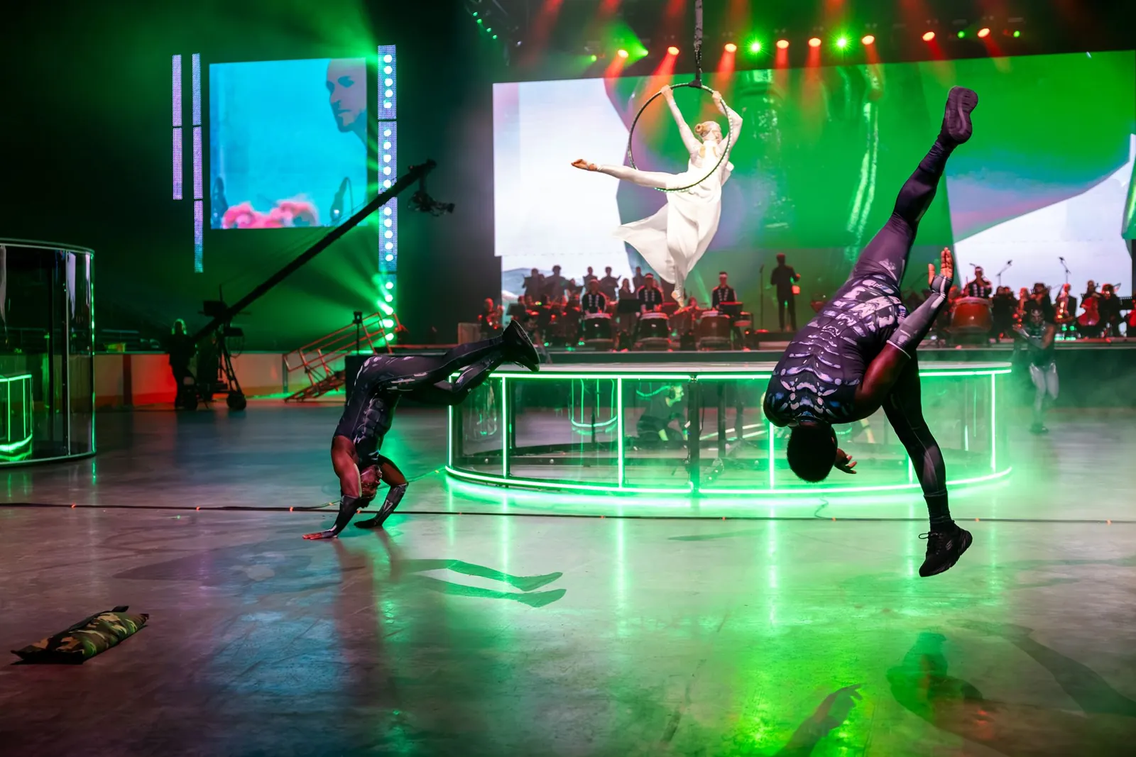 Breakdancers performing on stage with live musicians at TennoCon 2026