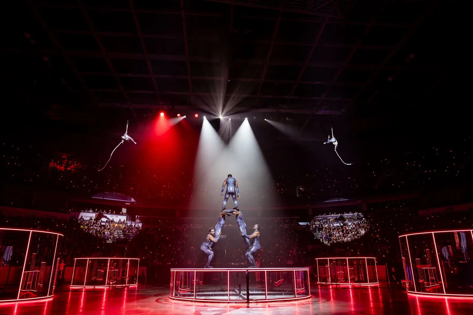 Acrobats forming a human tower centre stage at TennoCon 2026