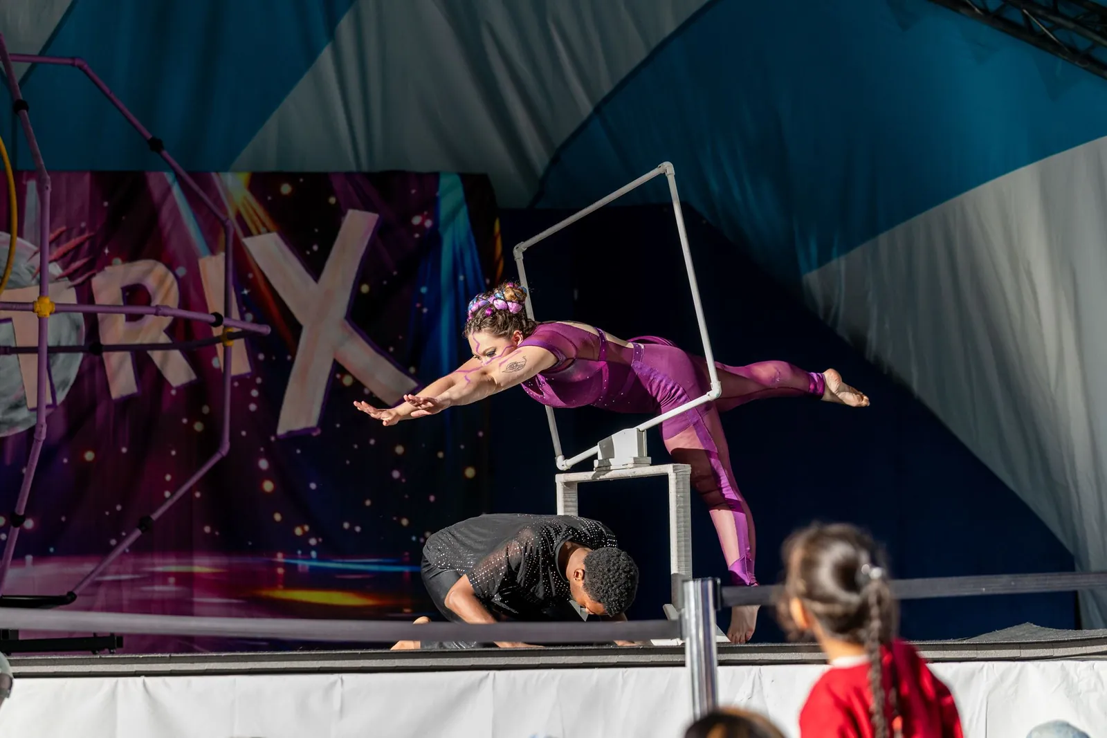 Acrobat diving through a hoop during the K-POP Cirque Tribute show