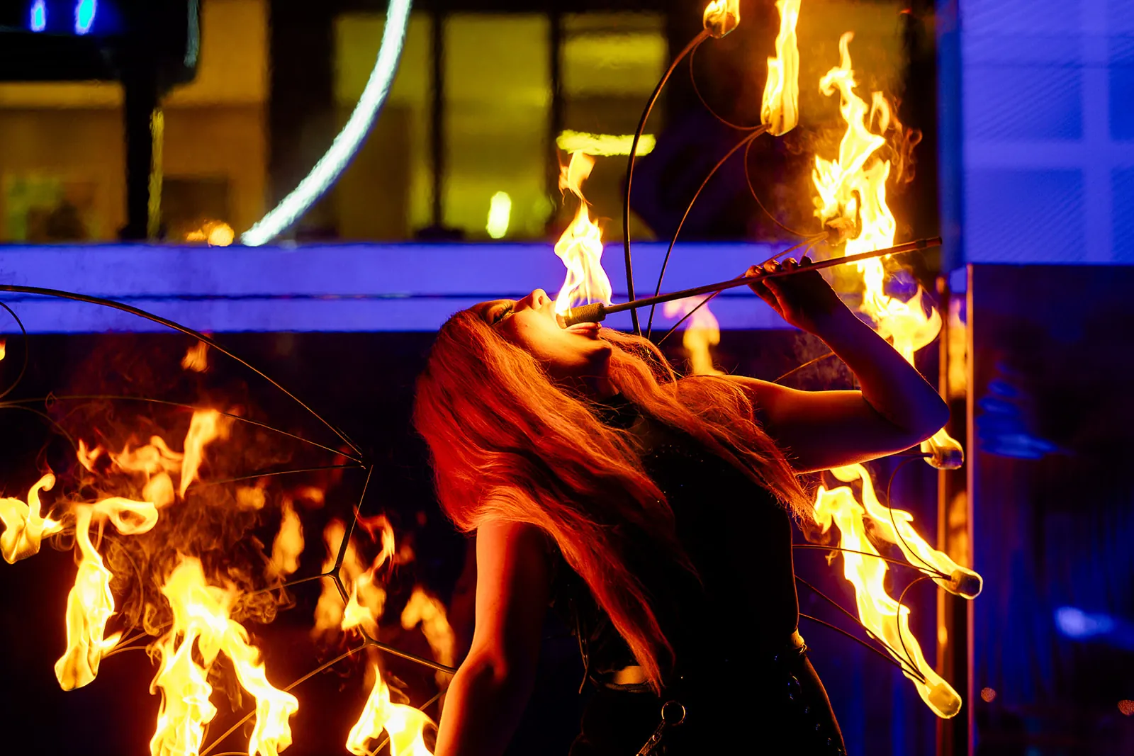 Close-up of a fire performer with flaming fans