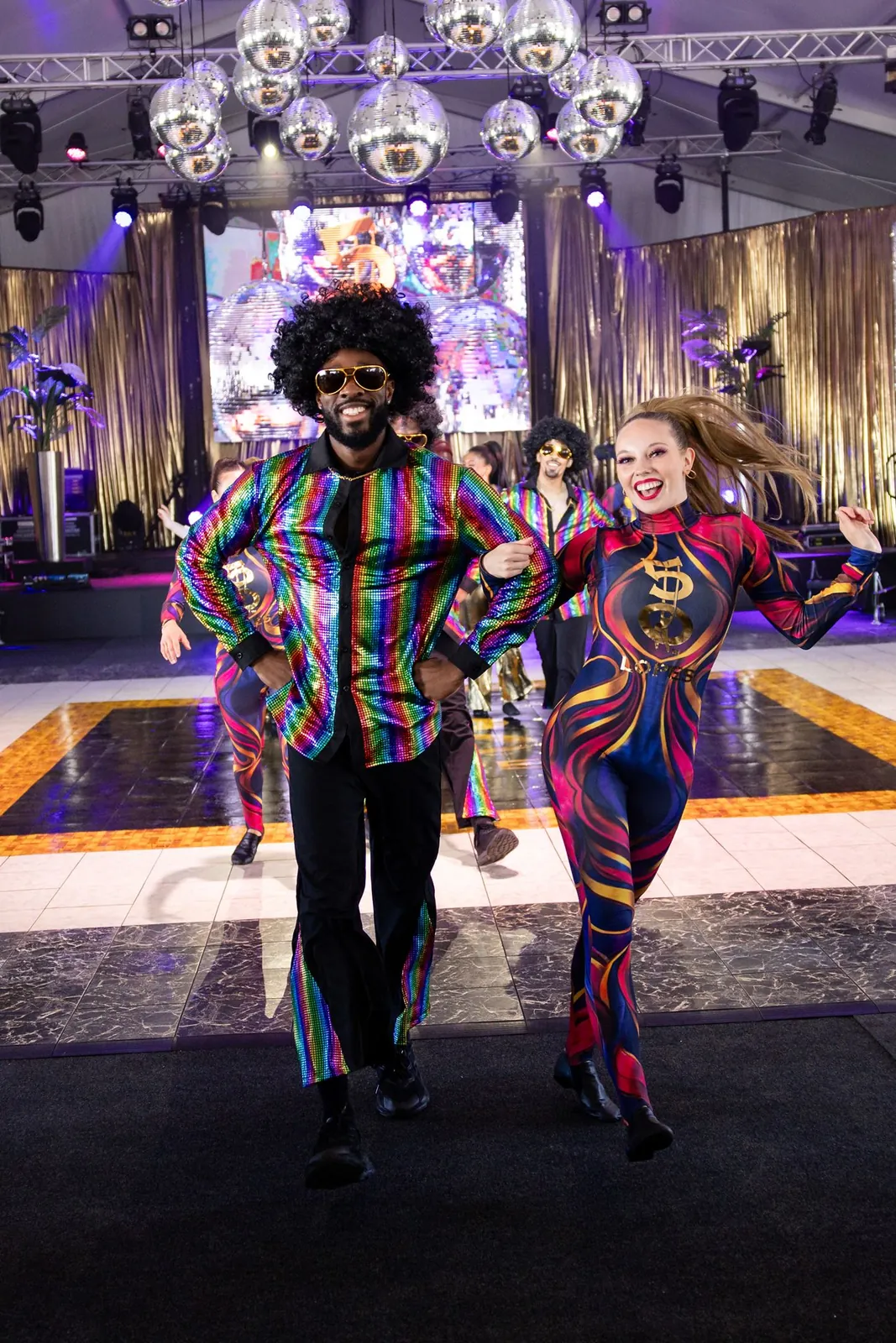 Disco dancers in colourful sequined costumes