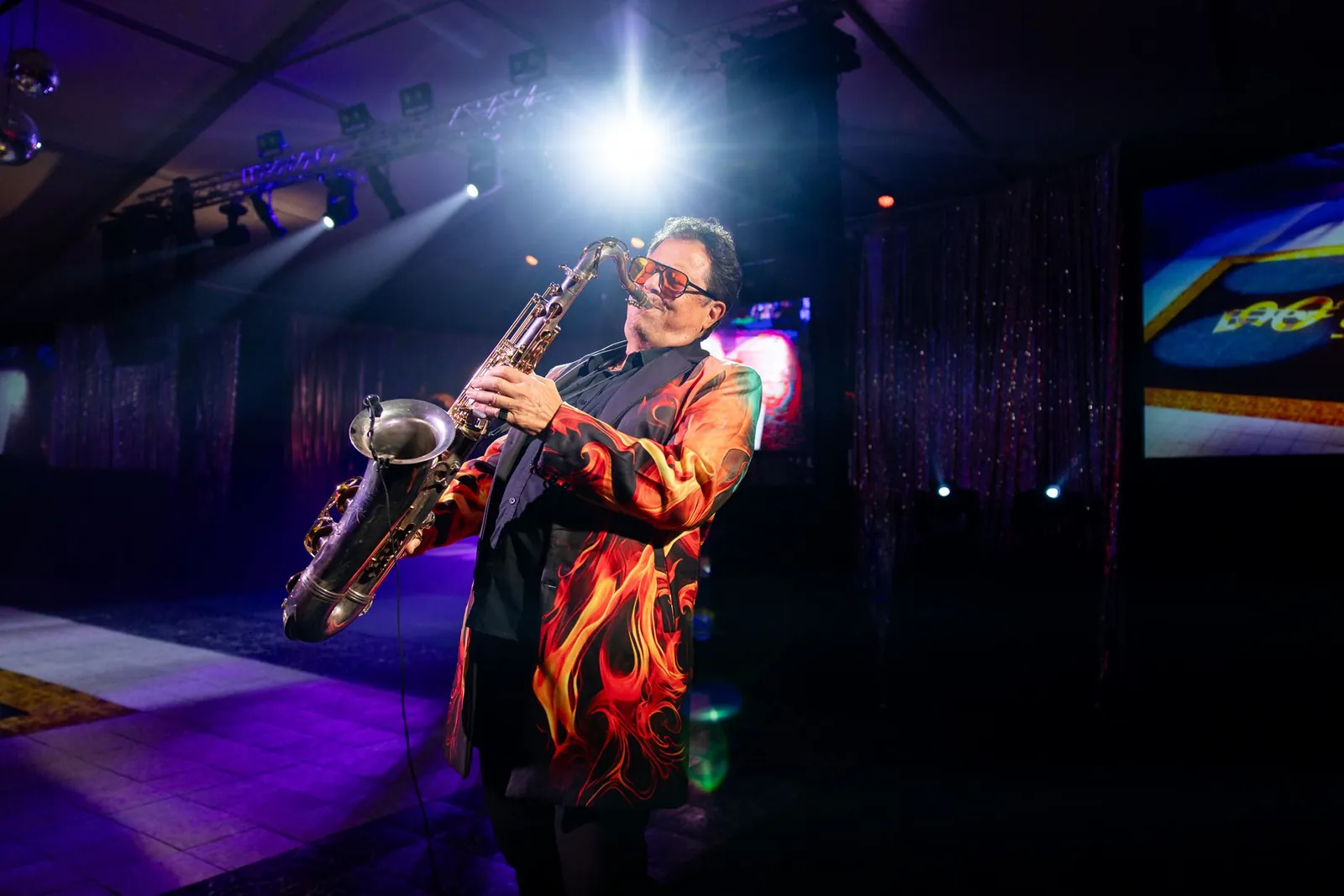 Saxophonist performing under a spotlight
