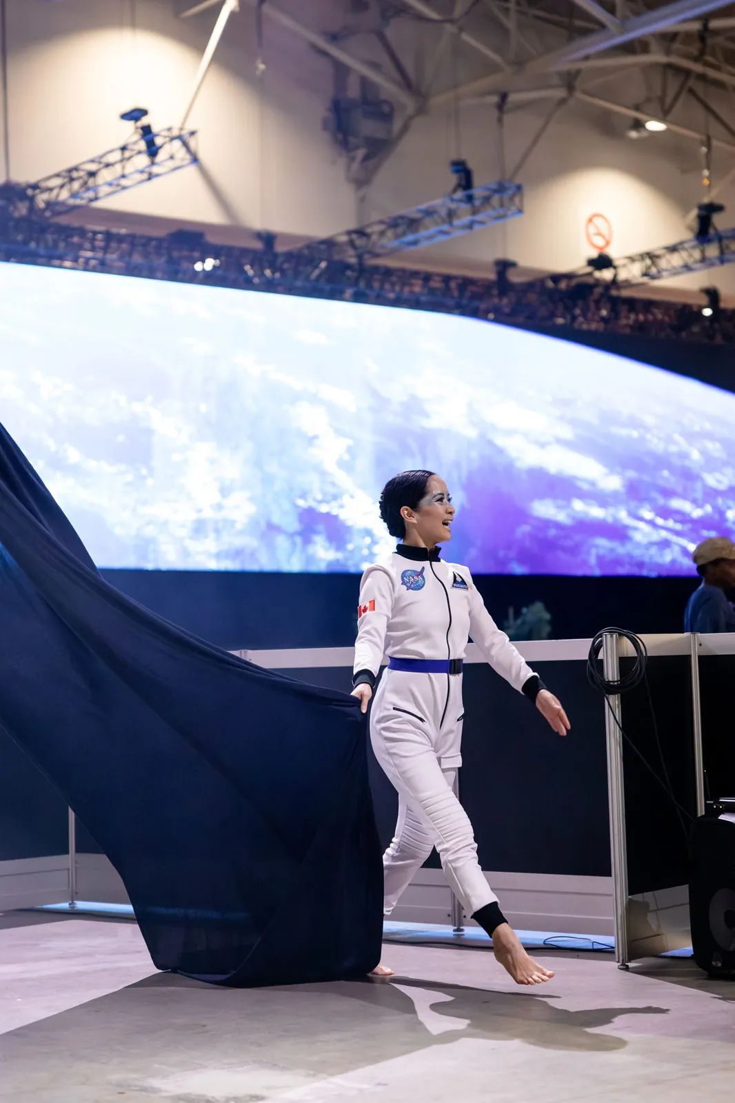 Astronaut character in front of a planet projection