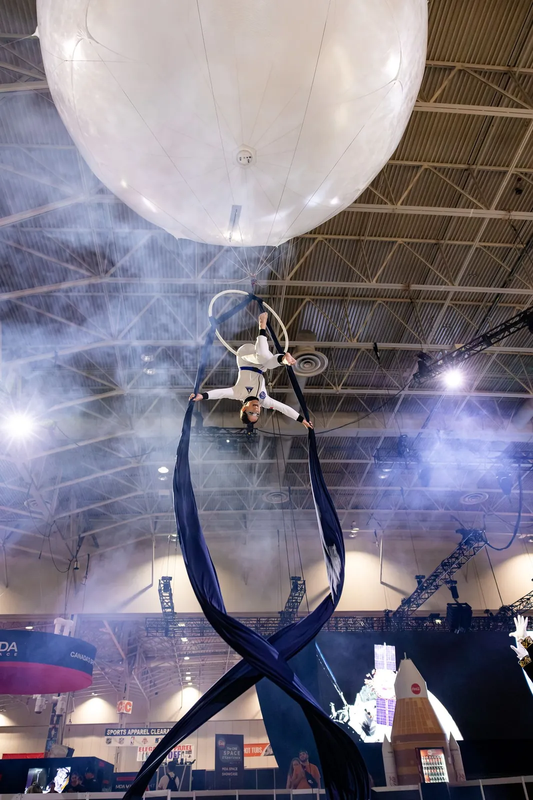Aerialist on silks beneath the aerial balloon