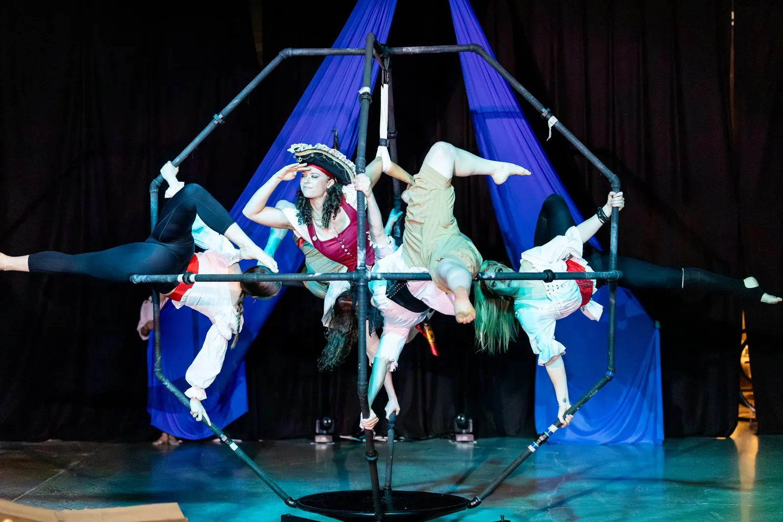 Acrobats in pirate costumes on the DaVinci apparatus