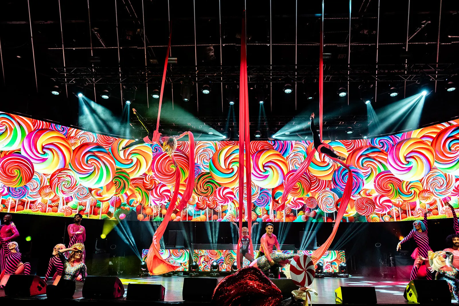 Silks tree performance in front of a colourful candy backdrop