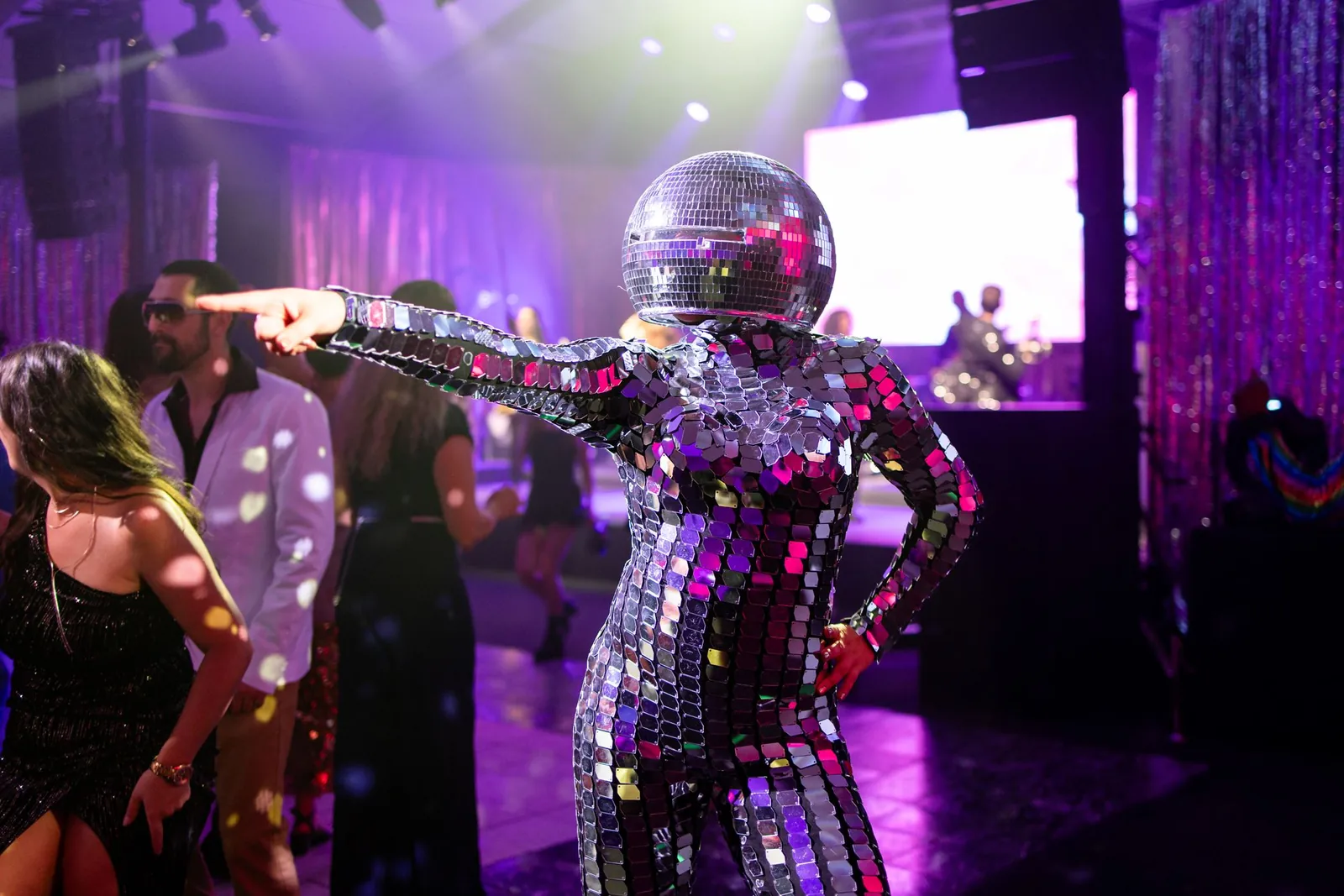 Disco ball dancer on the dance floor with guests