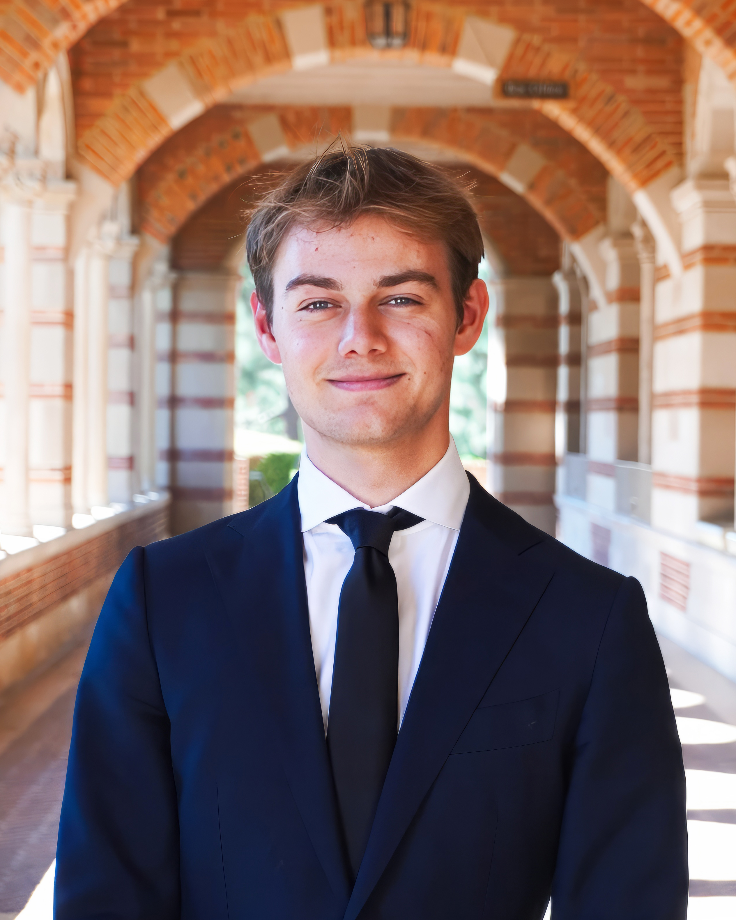 A man wearing a blue suit and blue tie