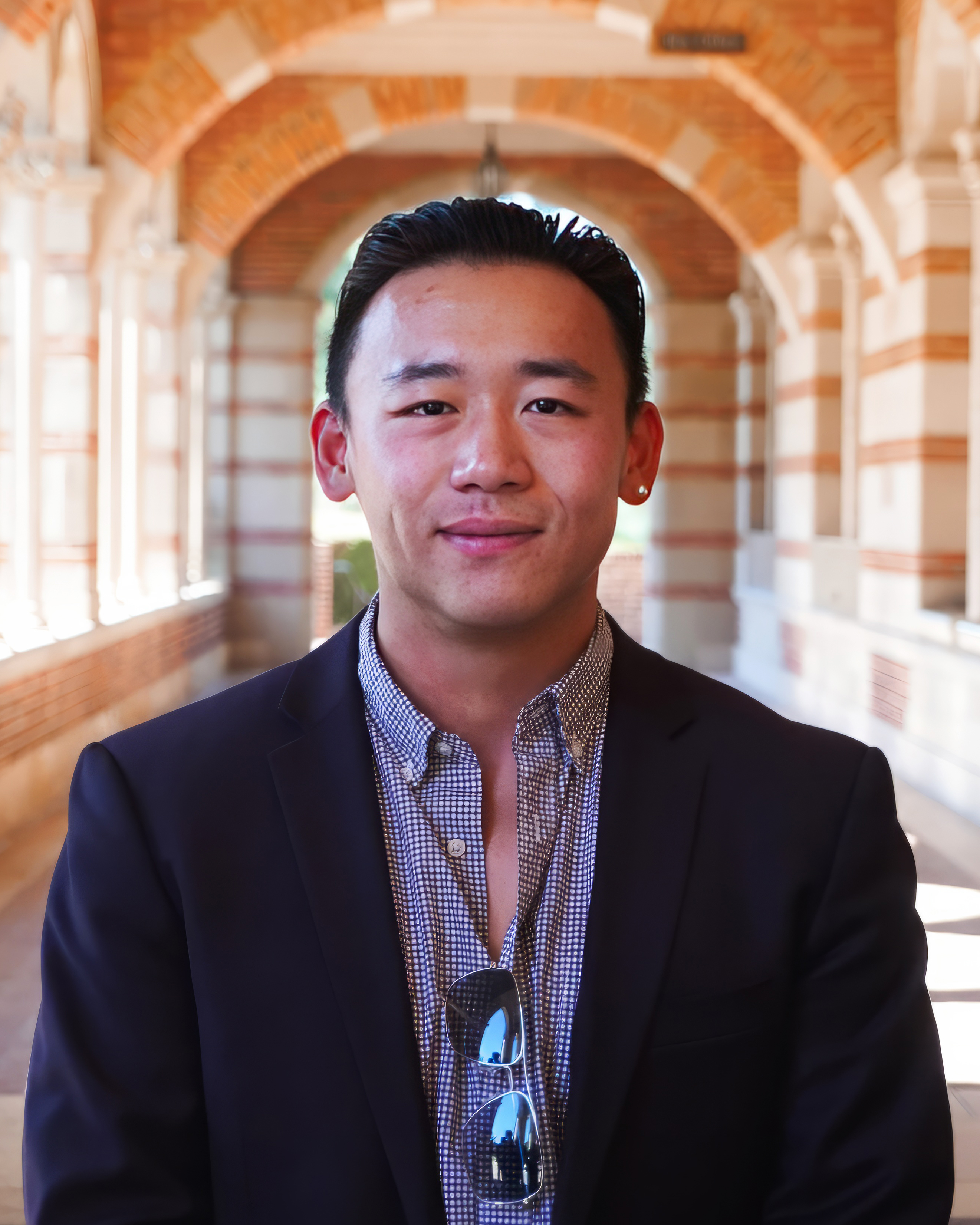 A man wearing a purple suit and black tie
