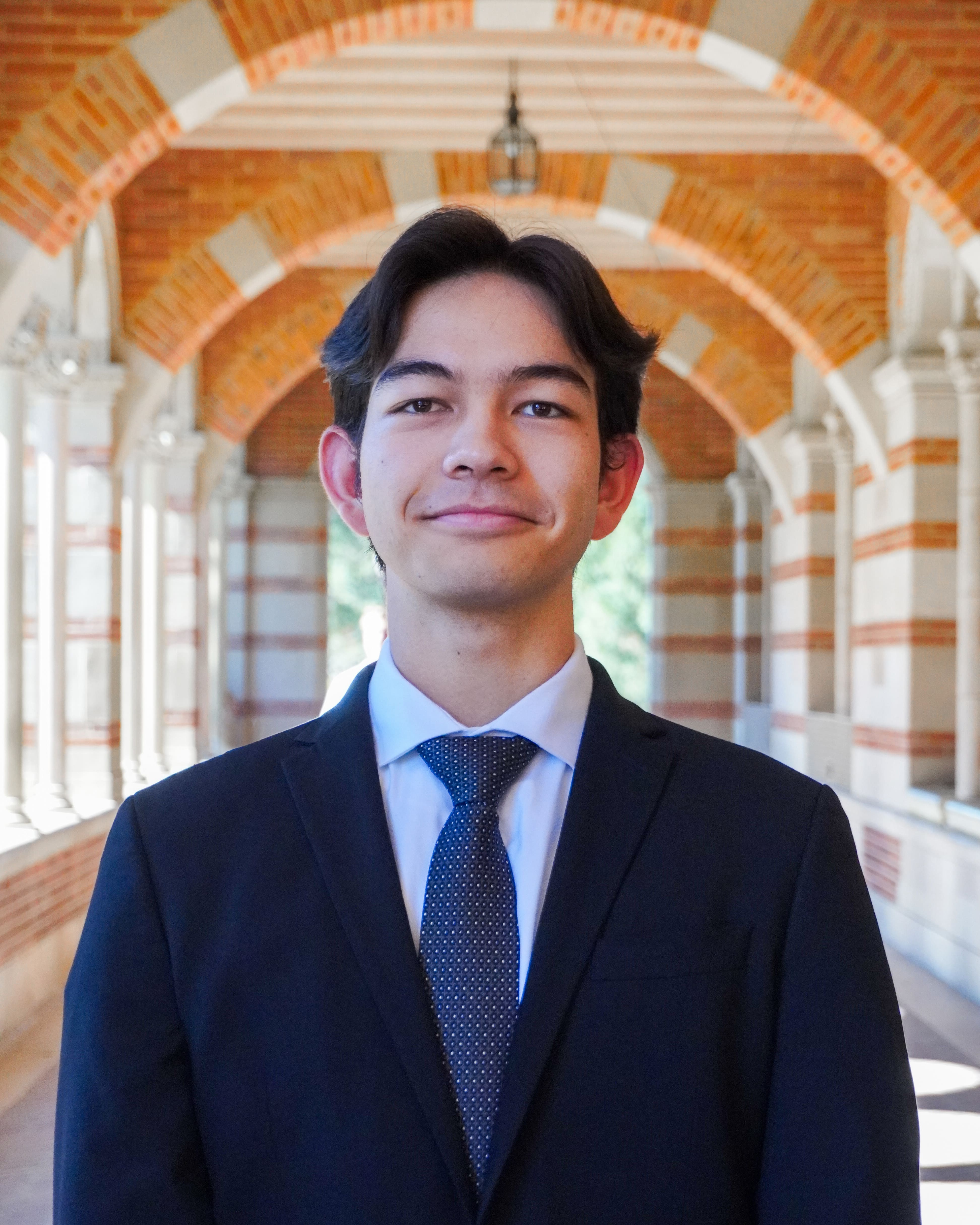 A man wearing a blue suit and blue tie