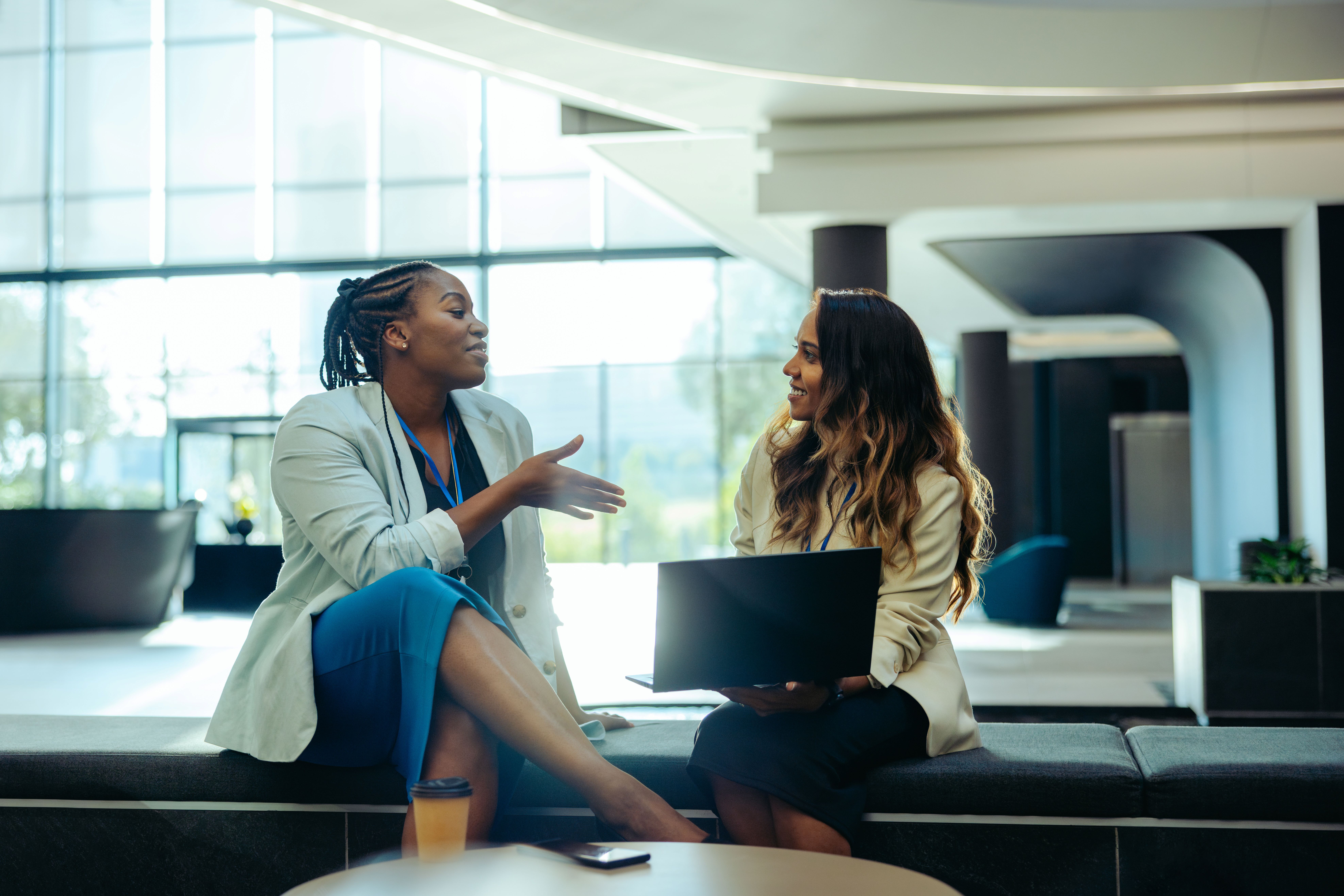 Experienced professional mentoring a colleague during a one-on-one meeting