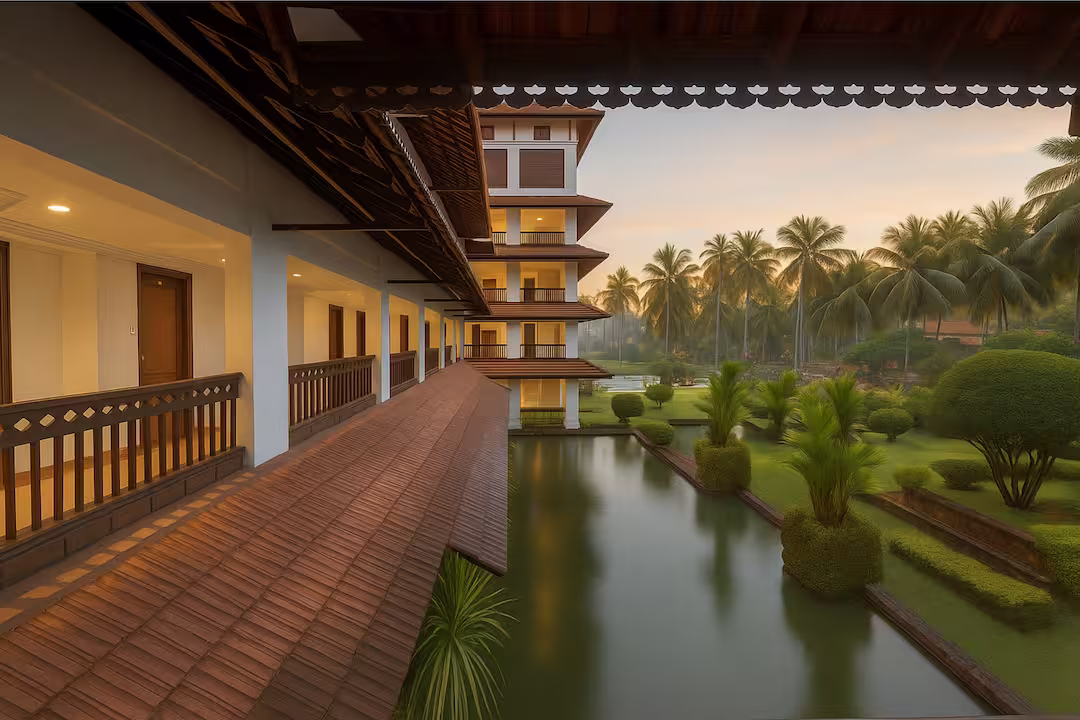 Ayurvedic wellness resort courtyard with traditional Kerala architecture, tiled roofs, and reflection pool at sunrise