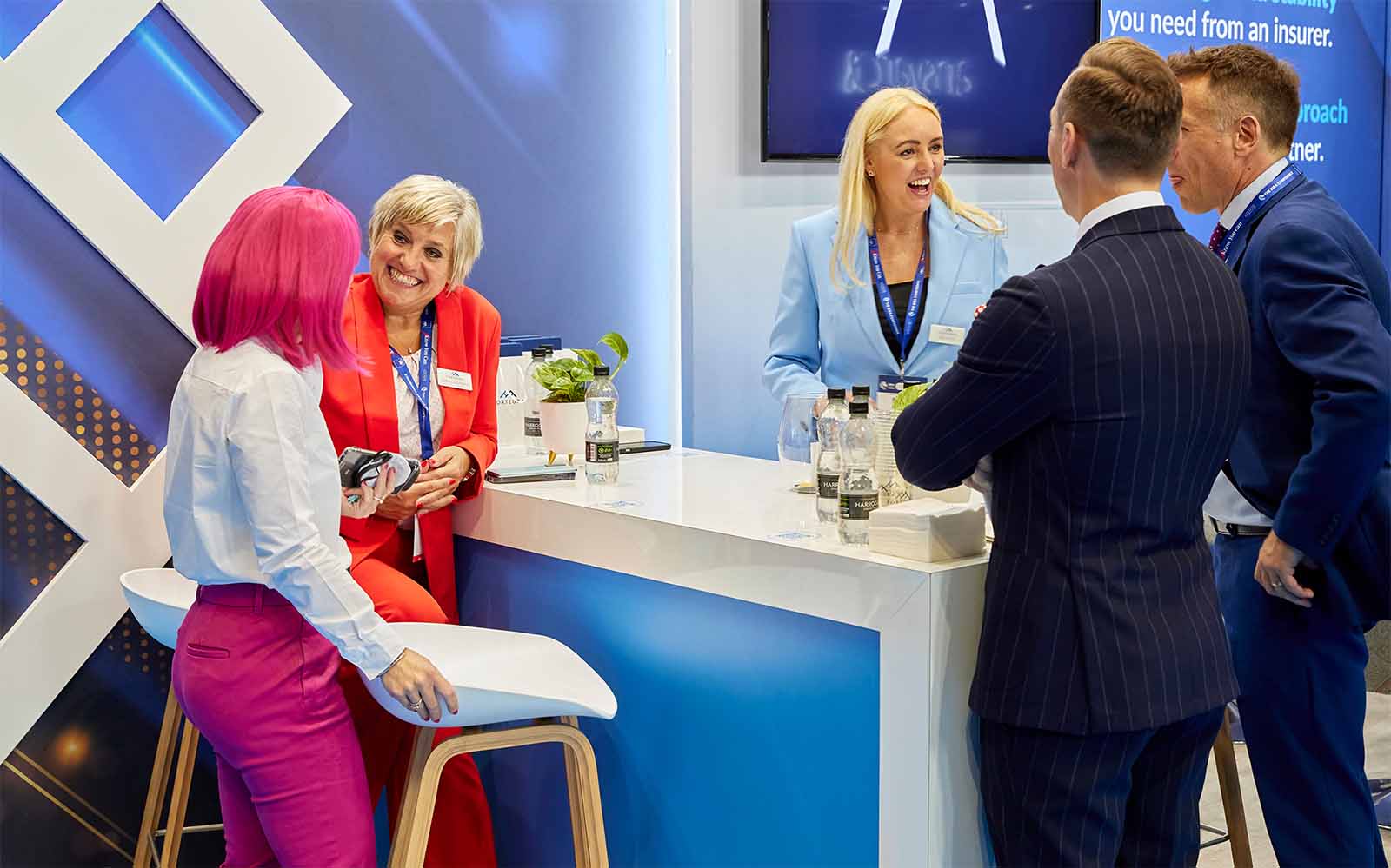 People networking and having discussions on a conference stand