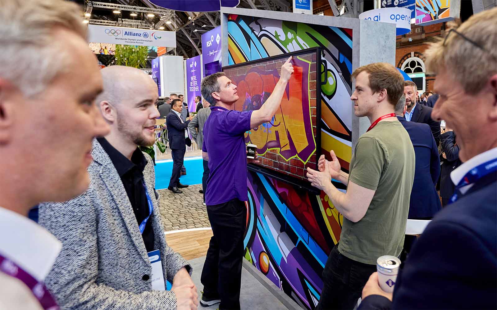 People congregating around a conference stand