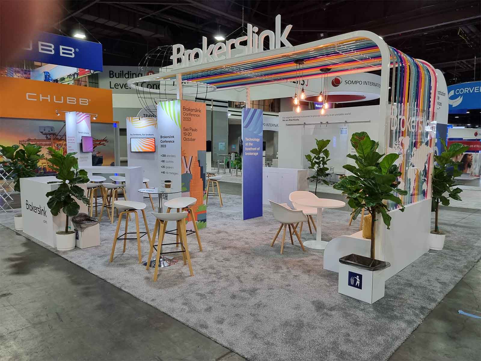 Group having a discussion in the meeting area of a conference stand