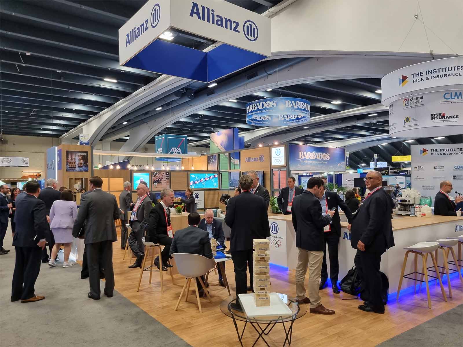 People congregated and networking in front of a conference stand