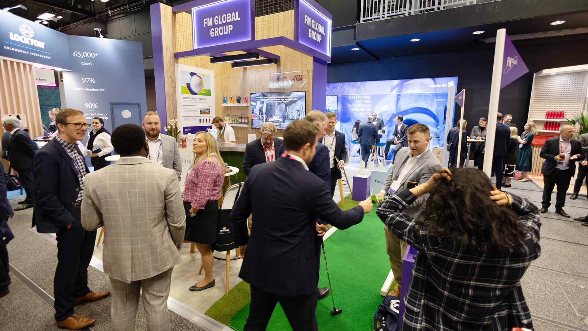 Group having a discussion in the meeting area of a conference stand