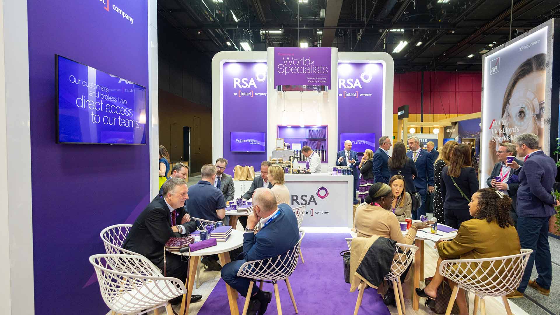 Man paying a claw machine on a conference stand