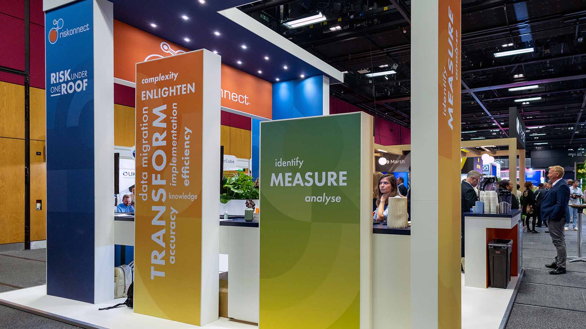 People congregating around a conference stand