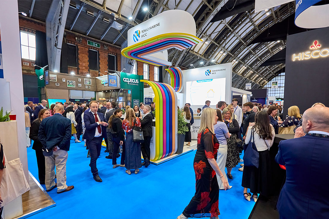People networking and having discussions on a conference stand