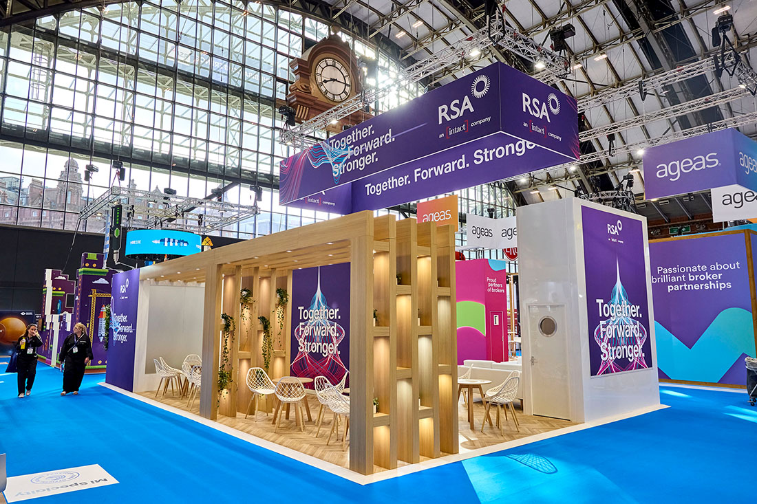 People networking and having discussions on a conference stand