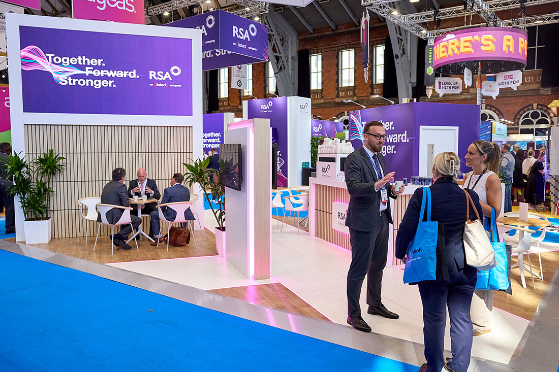 People networking and having discussions on a conference stand