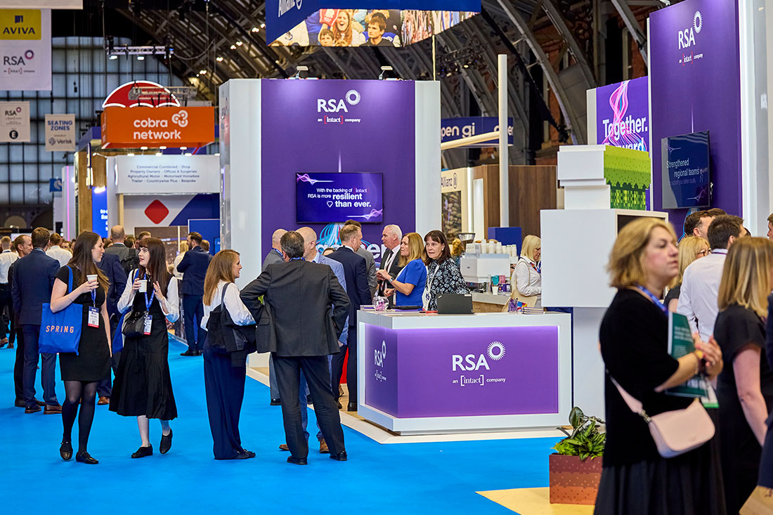 People networking and having discussions on a conference stand