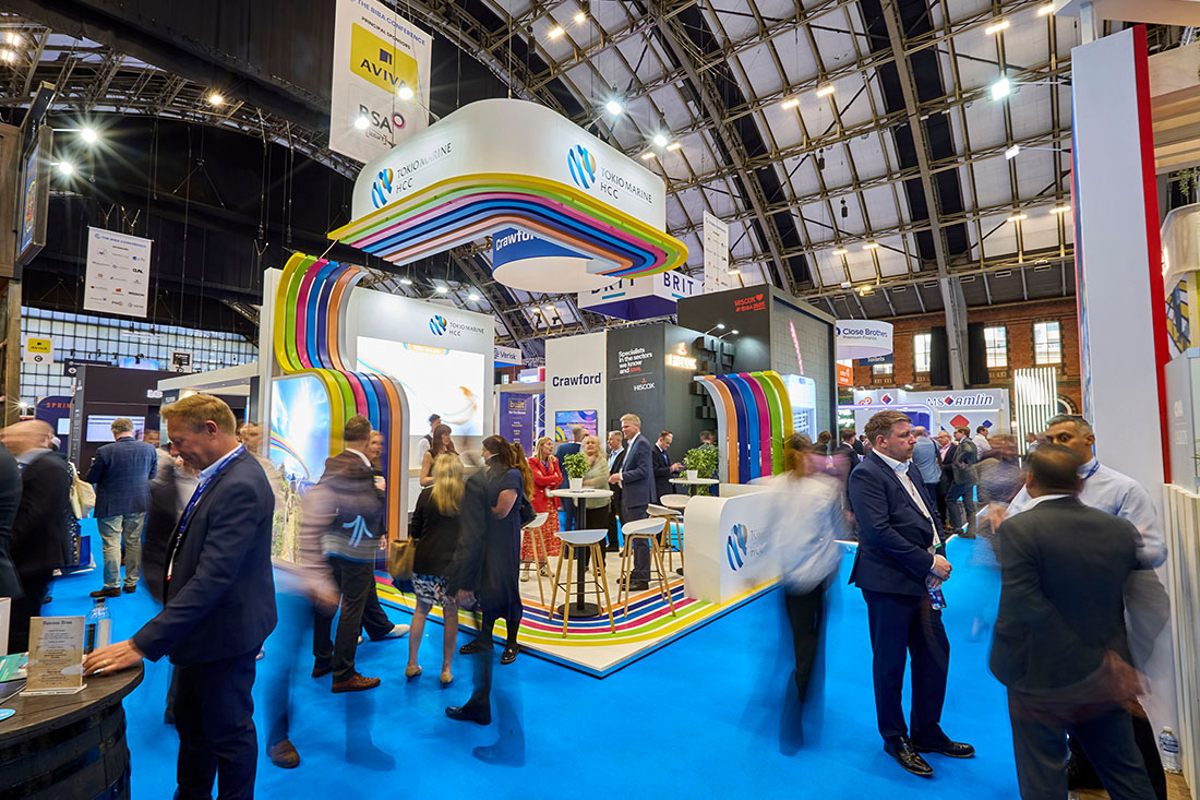 People networking and having discussions on a conference stand