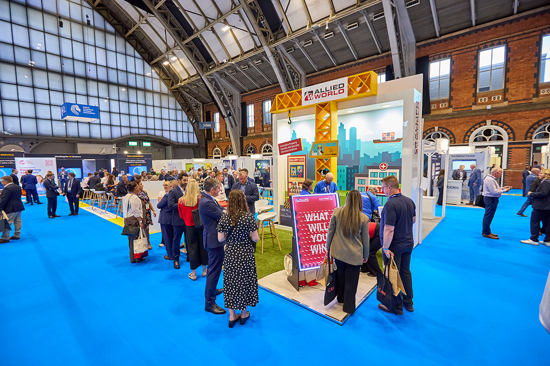People networking and having discussions on a conference stand