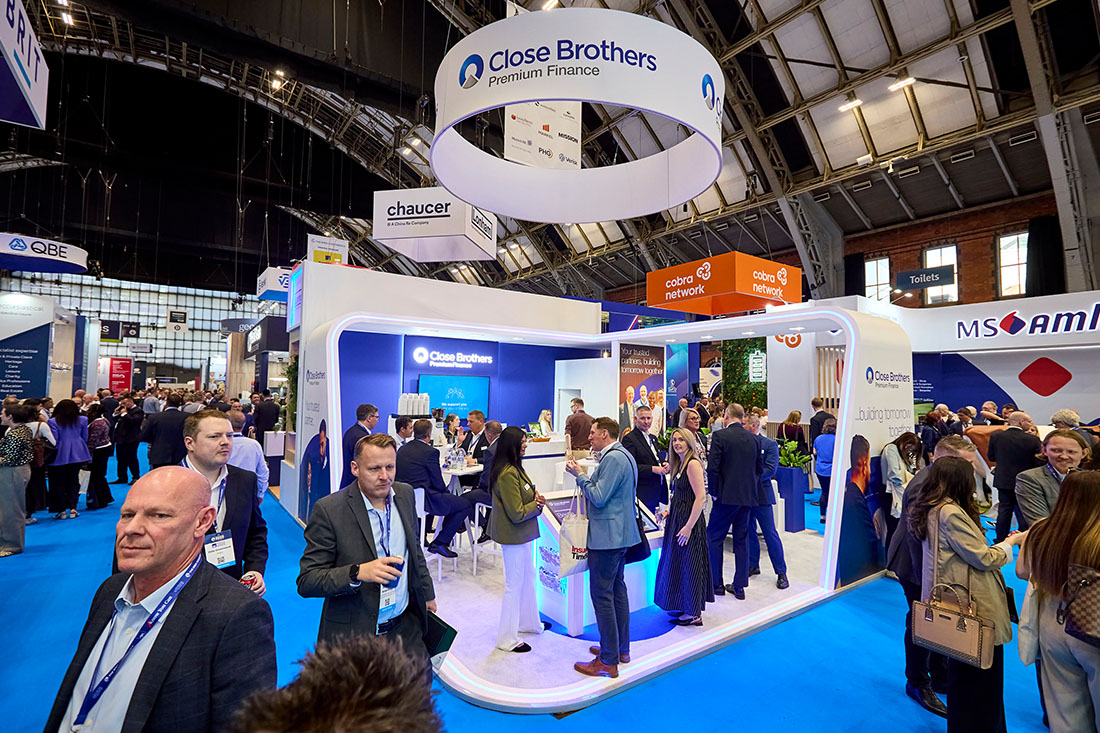 People networking and having discussions on a conference stand