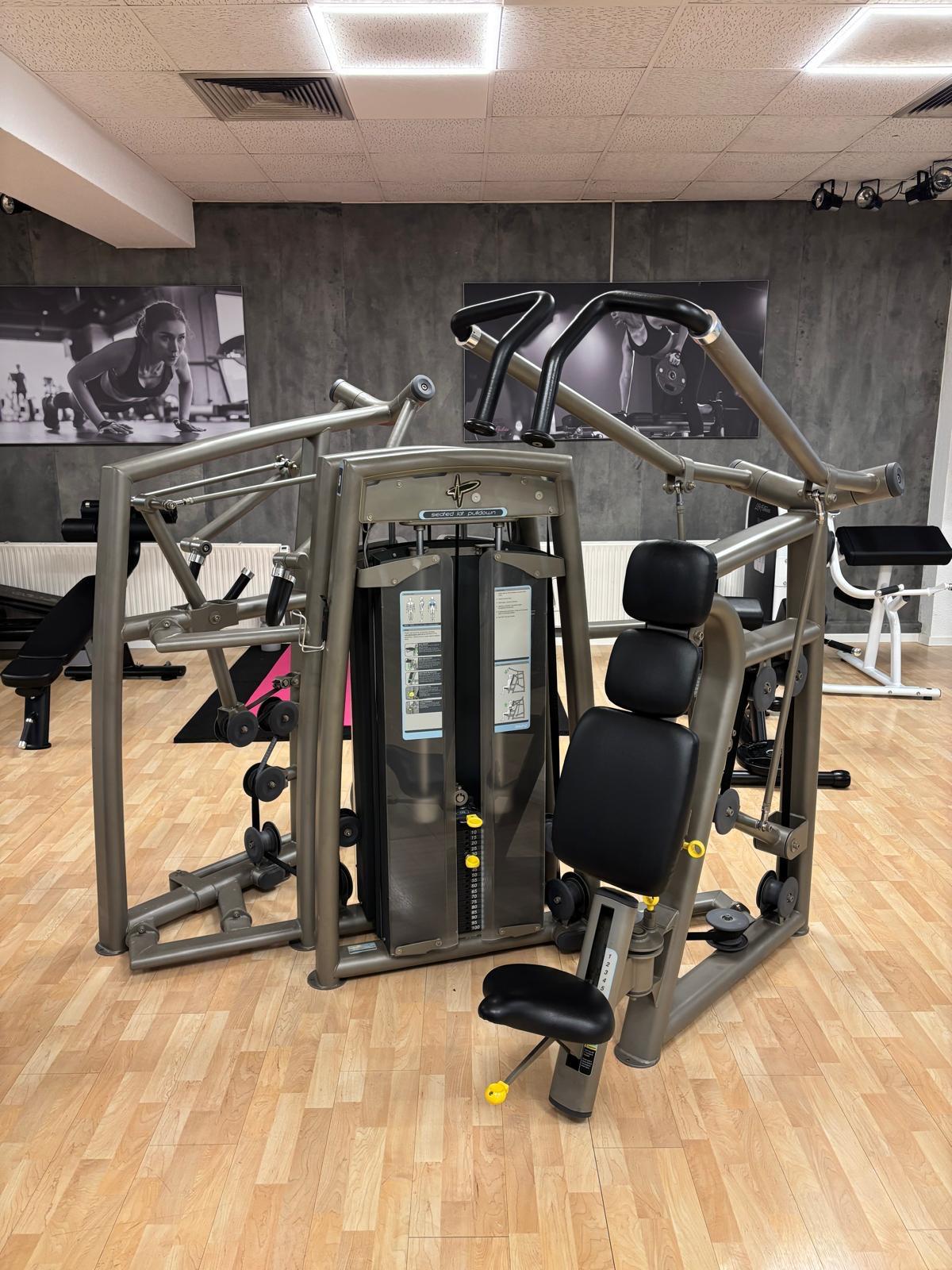 Multi-function seated chest press and lat pulldown workout machine with black padded seats in gym.
