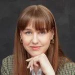 Paulina Steponaviciute, Activities Coordinator at the Red Cross, facing camera with a neutral expression, long light brown hair, wearing a checked jacket.
