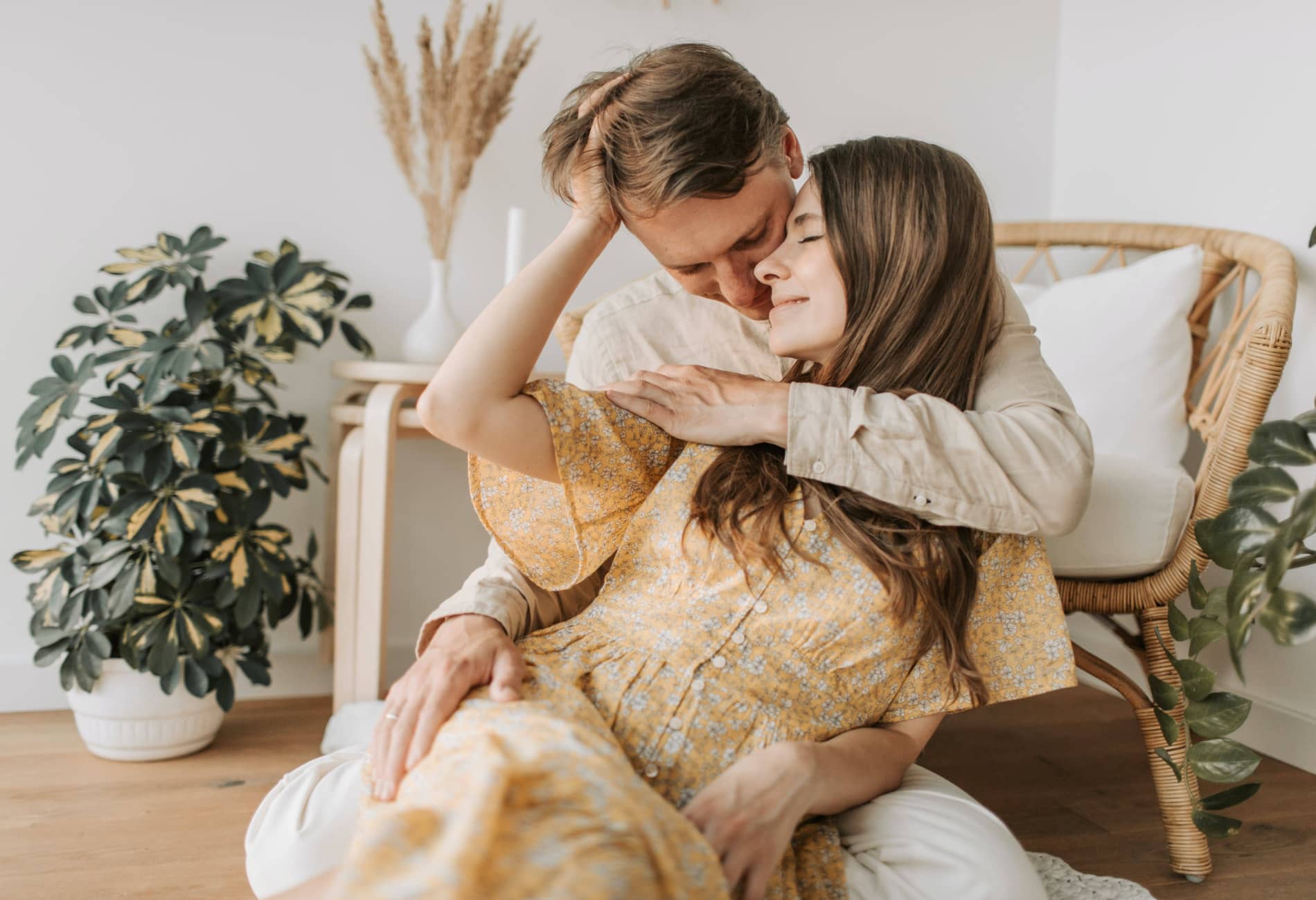 Couple caressing lovingly in a cozy Scandinavian-style apartment, showing warmth and emotional intimacy.