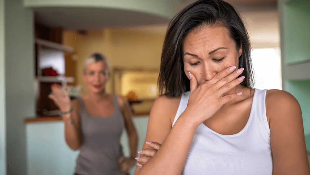 Couple in heated argument, one partner near tears, showing resentment tension.