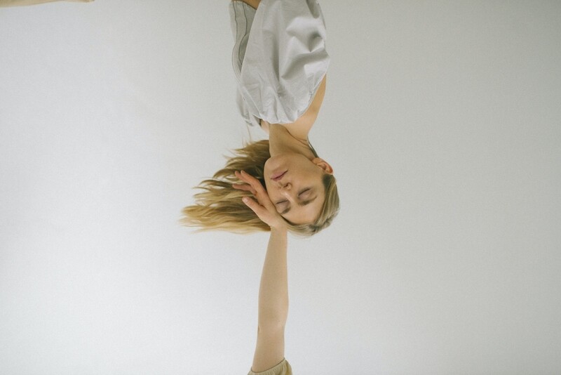 Artistic image of a woman upside down with closed eyes, symbolizing reflection and being able to count on others.