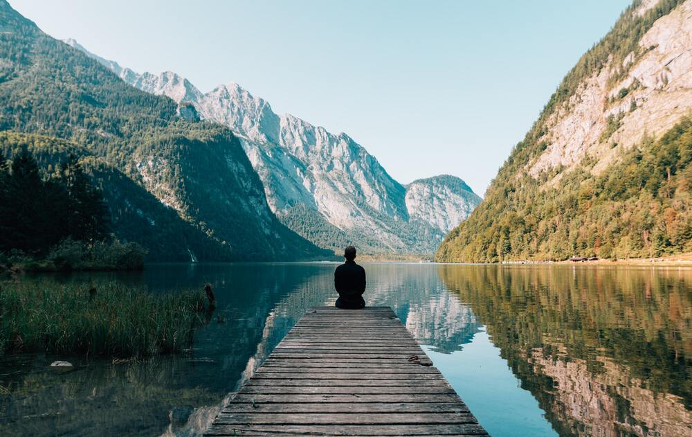 A serene mountain landscape reflected in a calm lake, symbolizing self-reflection, emotional balance, and the power of meeting oneself with clarity and stillness.