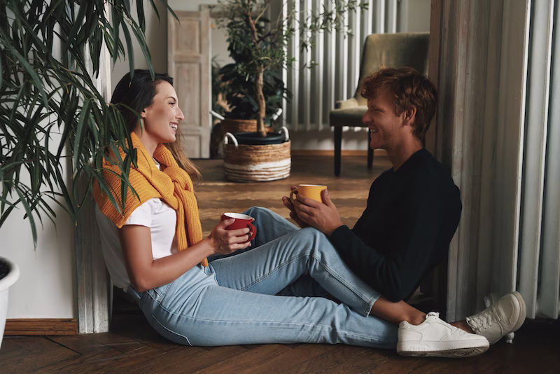 Comfortable couple talking over a shared beverage